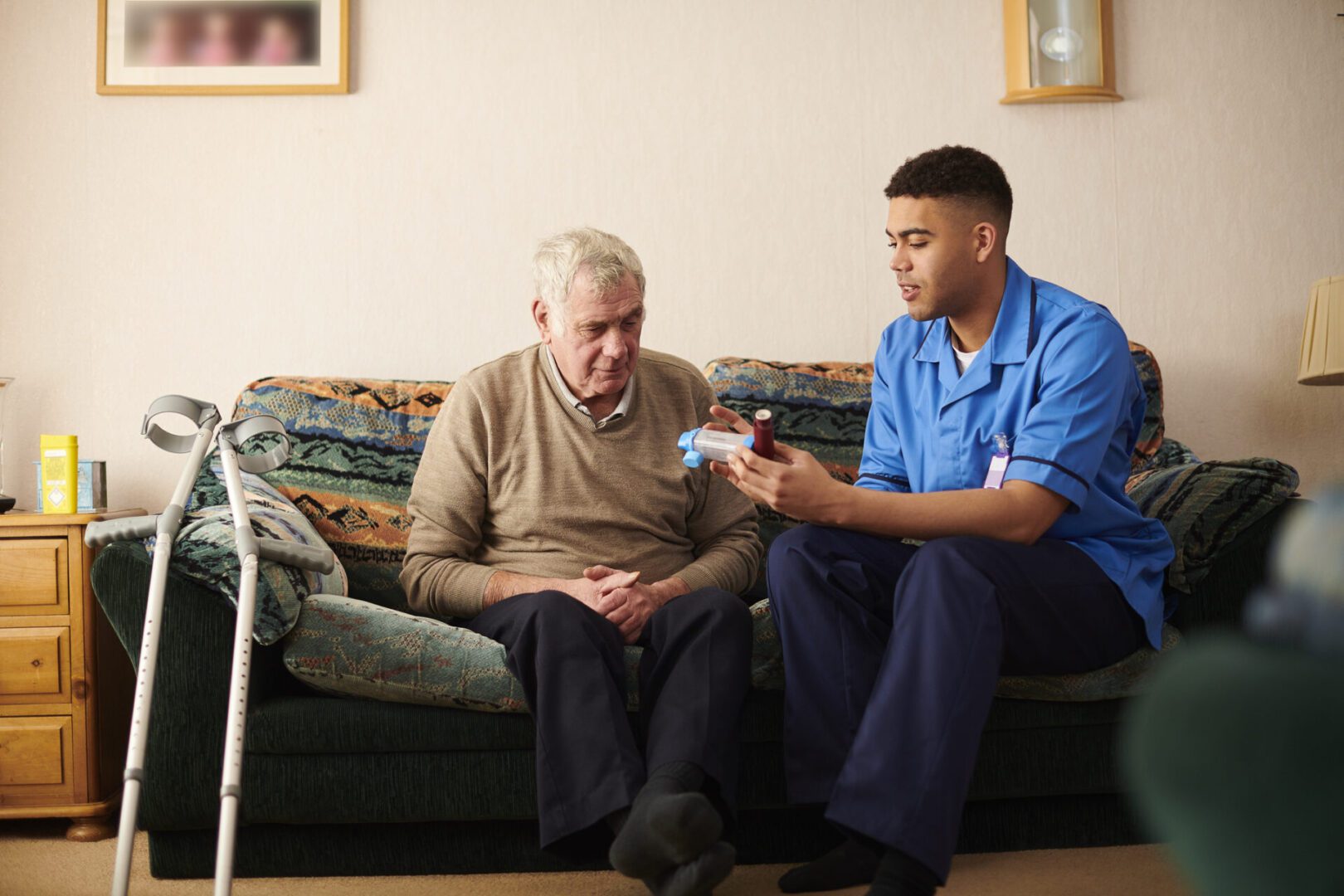 senior man with care worker at home