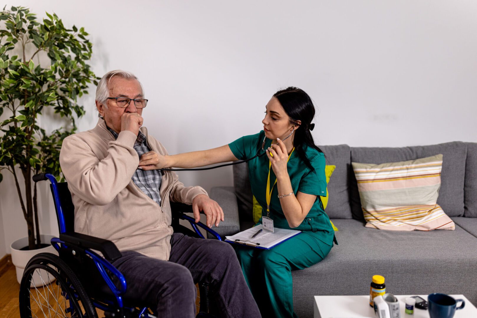 During a routine check-up, a female volunteer used a stethoscope to listen to the heartbeat of a senior man in a wheelchair. The volunteer's gentle touch and caring manner put the man at ease as she carefully checked for any signs of heart trouble.